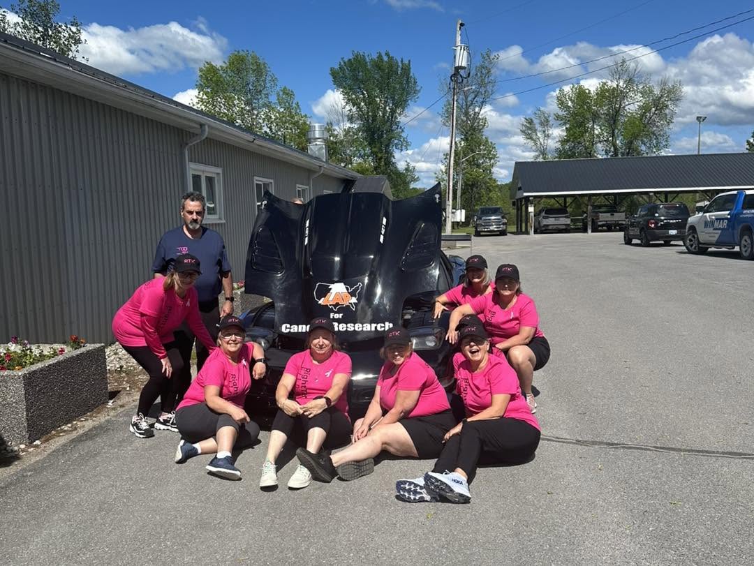 RightTrack Fitness Scrambled Legs & Achin group outdoors by a car