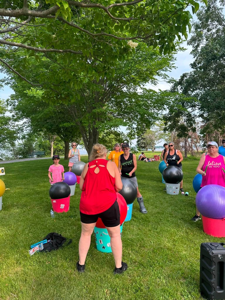 Participants drumming on yoga balls at Zwick's Waterfront Park